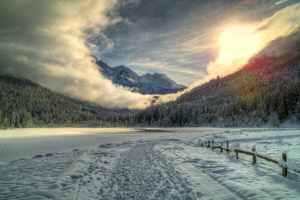 A snow-covered road along a snow-covered lake