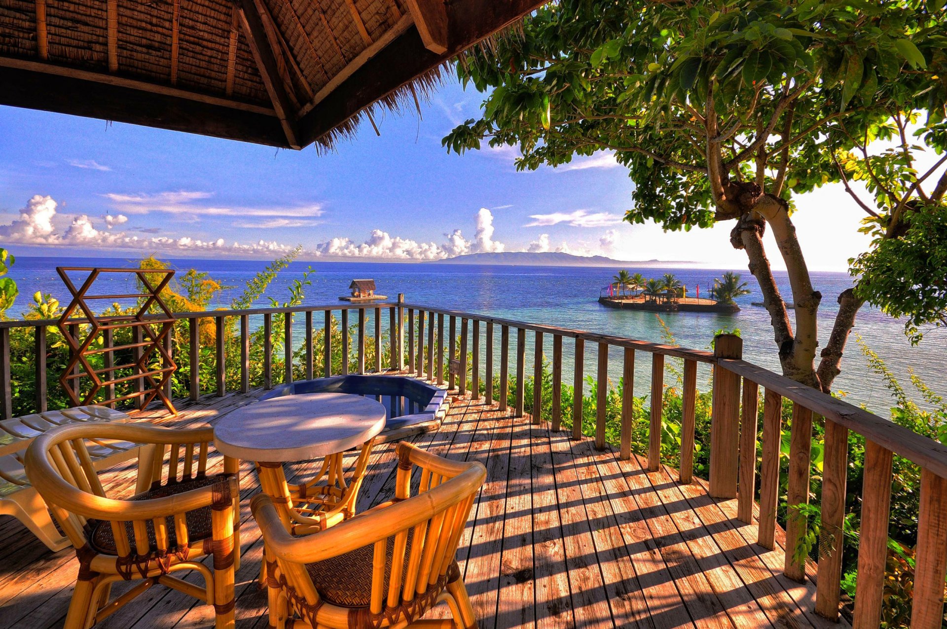 ky clouds sea mountain island verandah table chairs tree sports bungalow