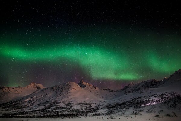 Northern Lights in the mountain slopes in winter