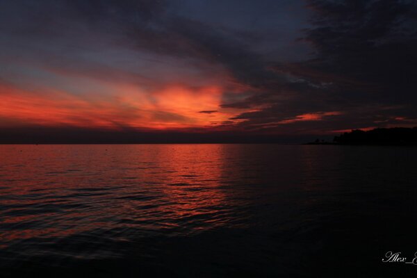 Red cloudy sky over the sea