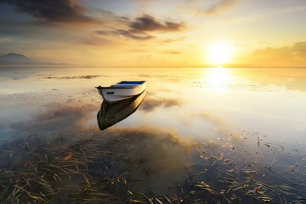 A lonely boat at sunset