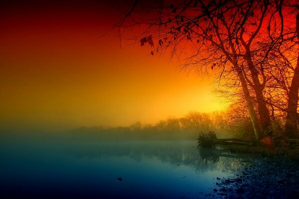 Bright autumn evening on a foggy river