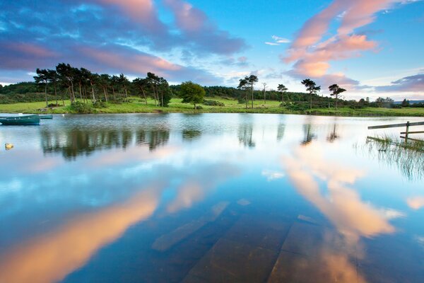 Summer landscape clouds in the water surface 