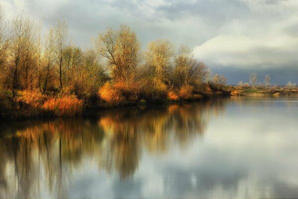 Reflection and sun of the autumn river